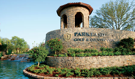 Grand stone entrance with waterfalls and botanical gardens