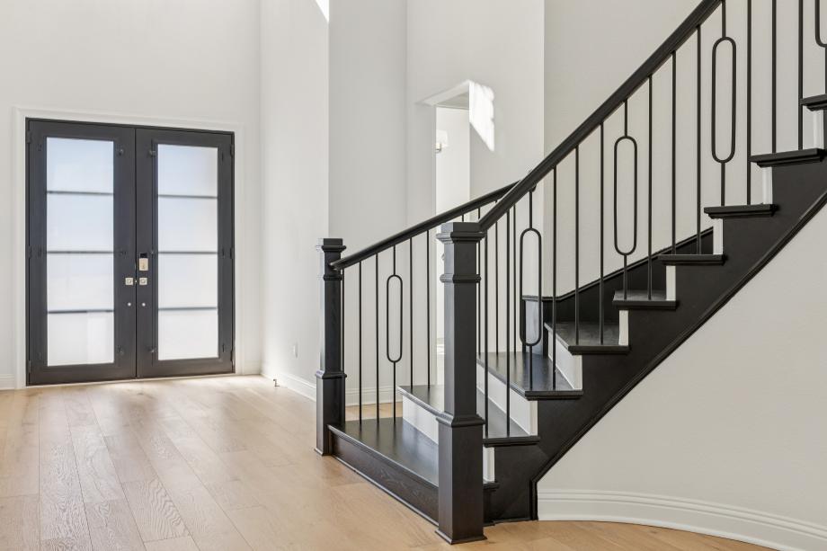 Beautiful curved staircase and double iron front door