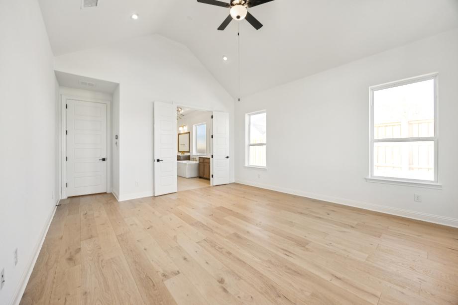 Primary bedroom features a cathedral ceiling