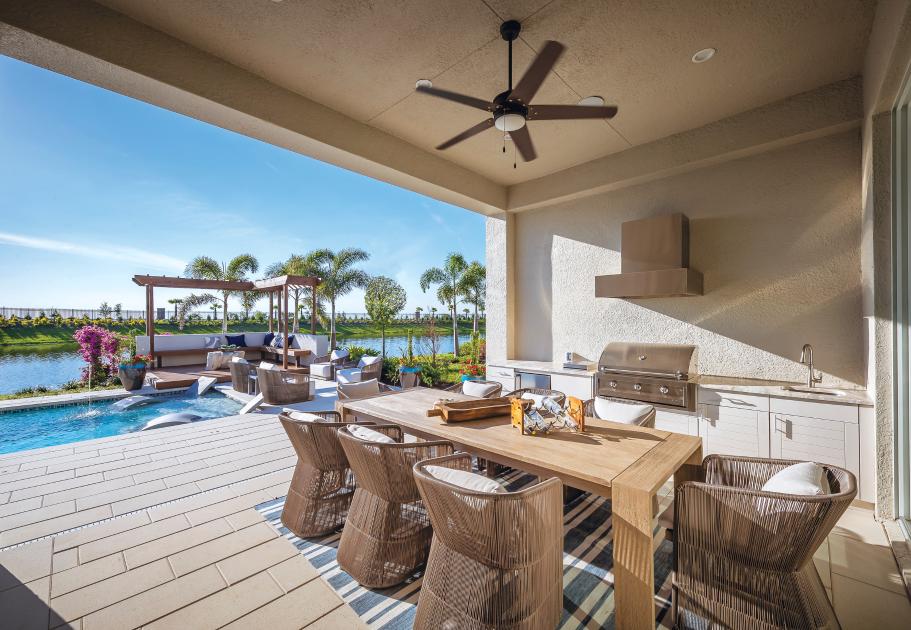 Covered outdoor living area with gas grill and beautiful lake views