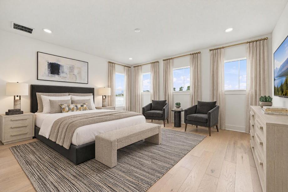 Spacious secondary bedroom with abundant natural light and sitting area