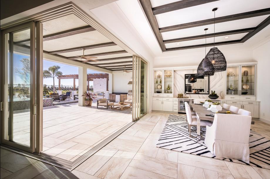 Casual dining area includes two beverage refrigerators and a 90-degree corner sliding door