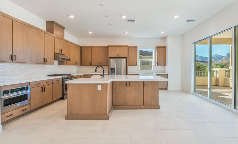 Gourmet kitchen with 42" slab upper cabinets and stainless appliances