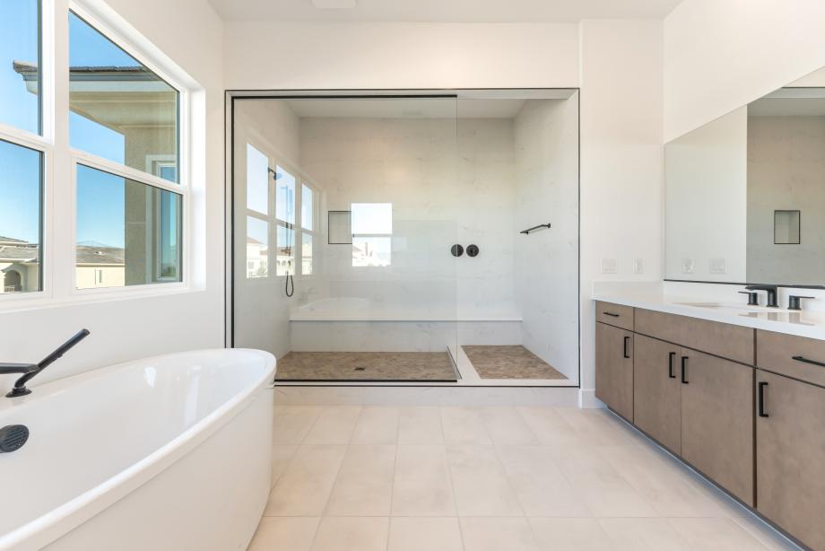 Stunning primary bath with large tile surround shower and soaking tub