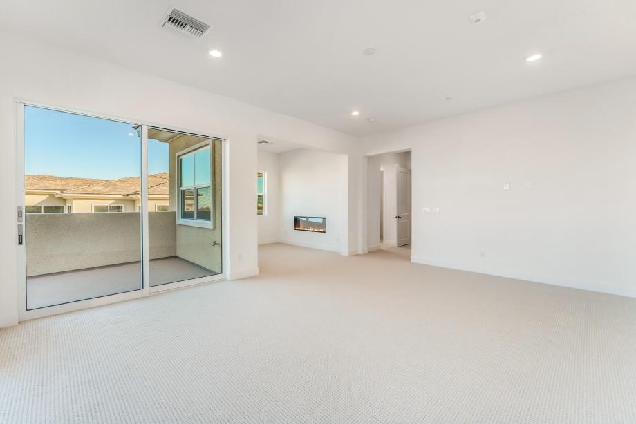 Primary bedroom retreat features cozy linear fireplace