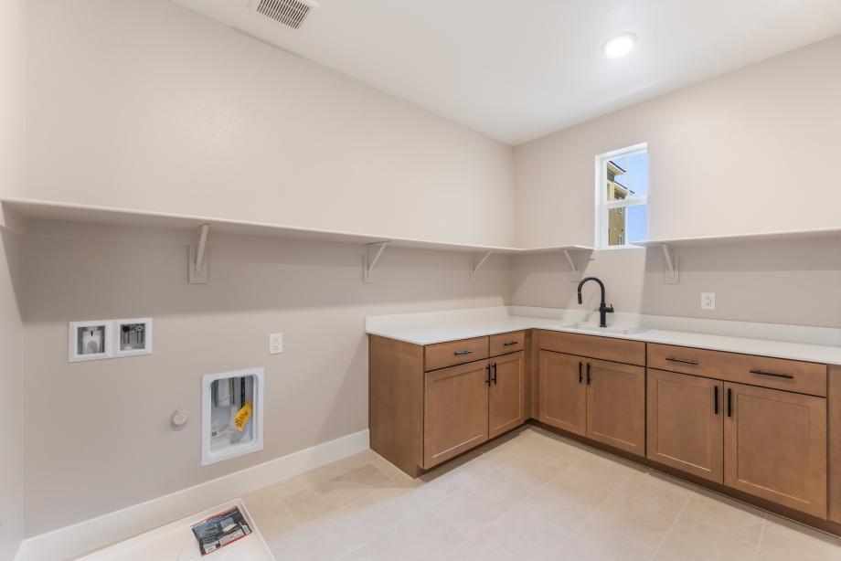 Spacious laundry with cabinets and sink