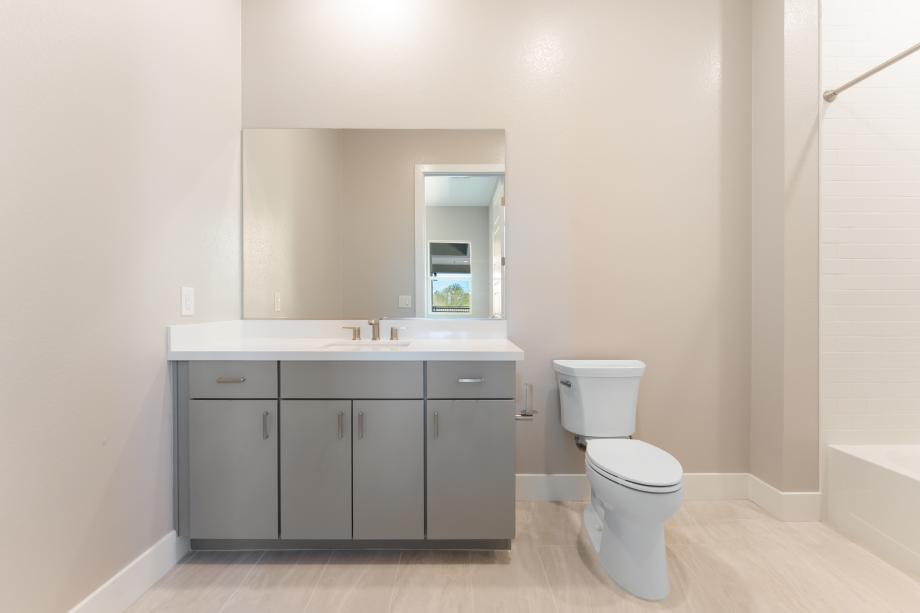 En-suite bath with large tile surround shower at secondary bedroom