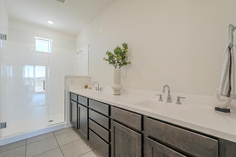 Gorgeous primary bathroom with dual-sink vanity and glass shower door