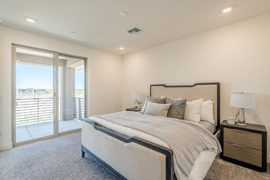 Primary bedroom suite with an abundance of natural light and direct patio access