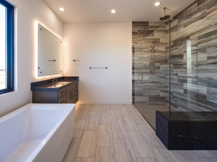Primary bathroom with luxe shower and standalone soaking tub