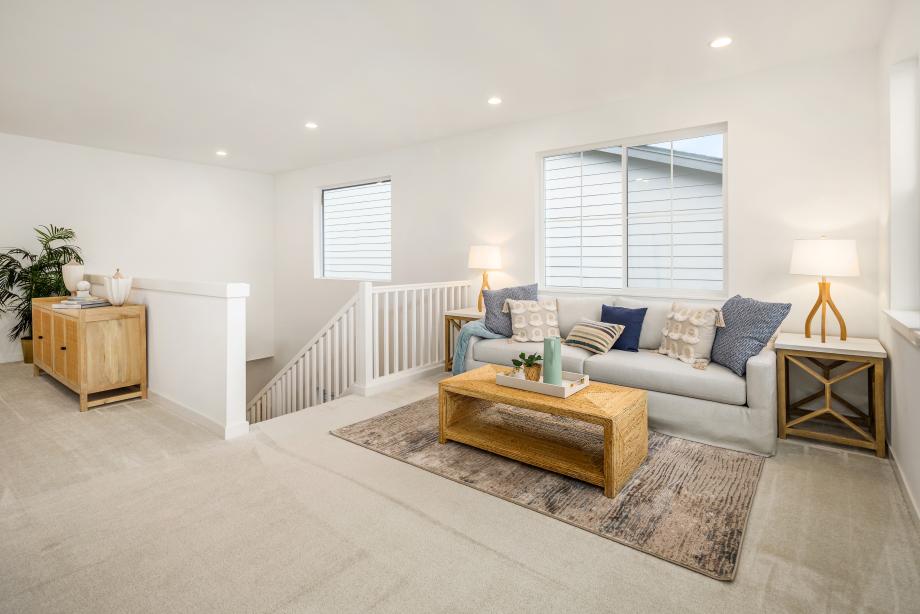 Second-floor loft provides a secondary gathering area for friends and family