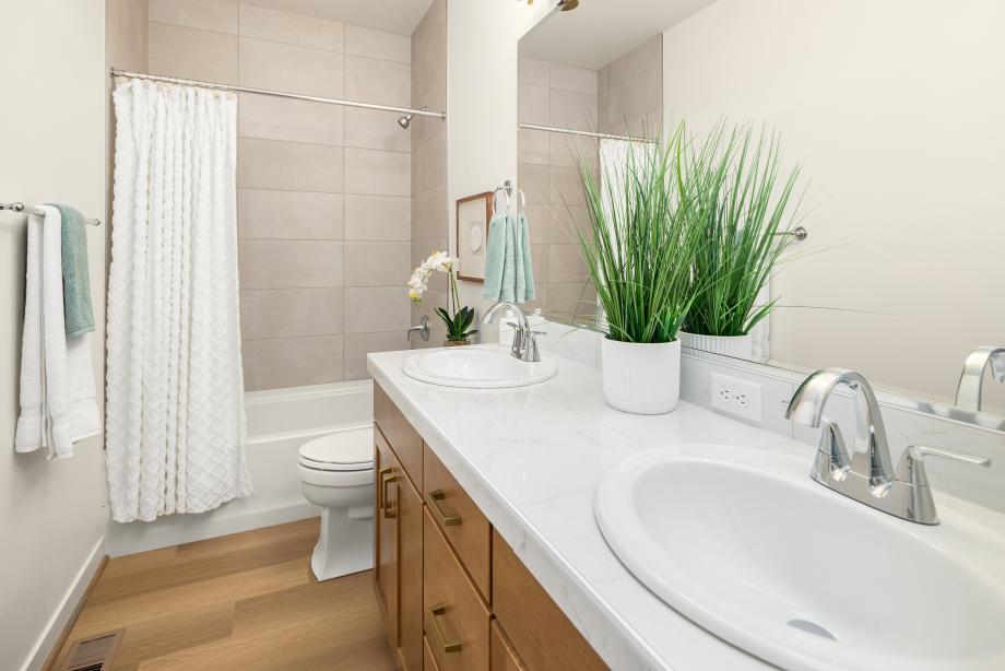 Secondary hallway bathroom features a dual-sink vanity