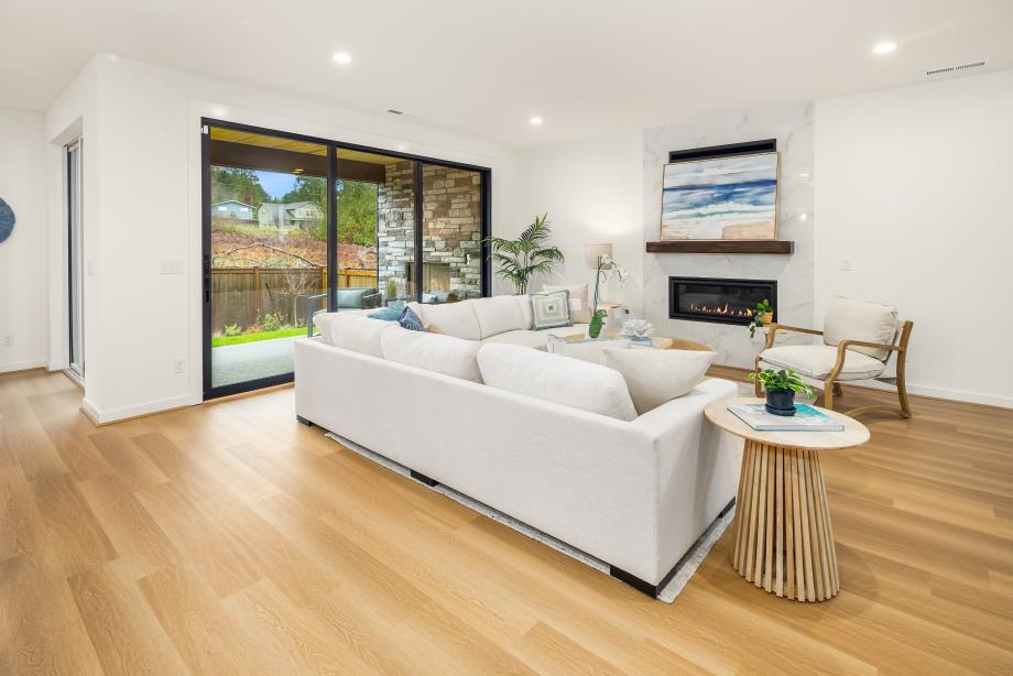 Spacious great room with gas fireplace & stacking glass doors to the patio