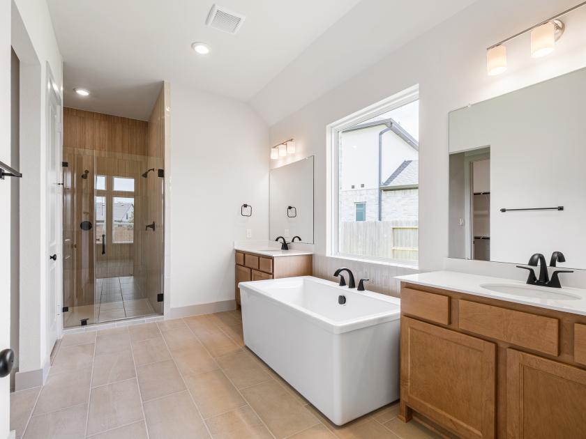 Primary Bathroom with tub and dual sinks
