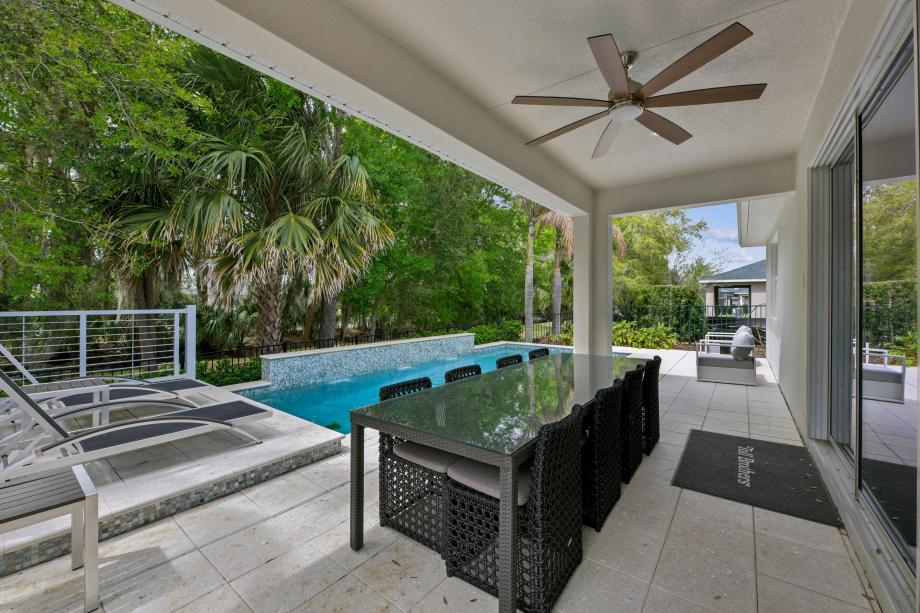 Breathtaking backyard oasis featuring a custom-shaped, crystal-clear pool