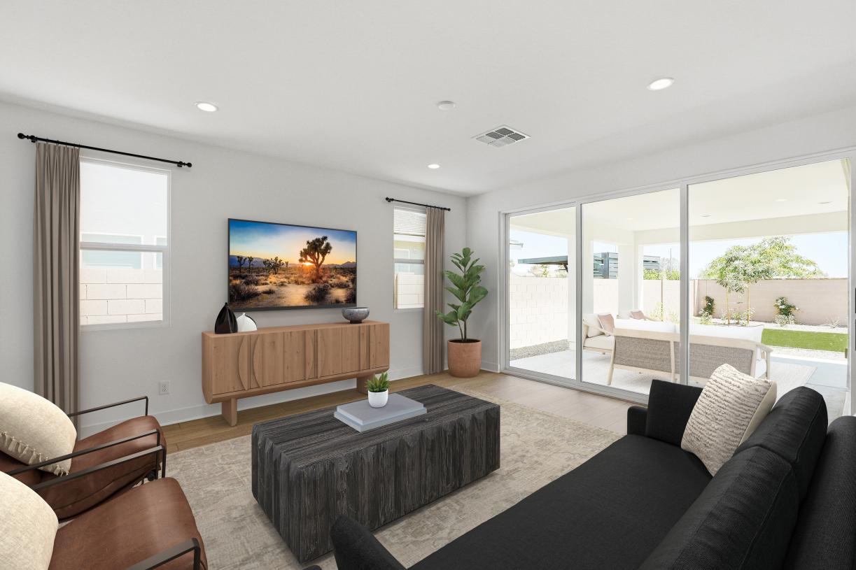 Spacious great room with beautiful flooring and sliding glass door leading to backyard