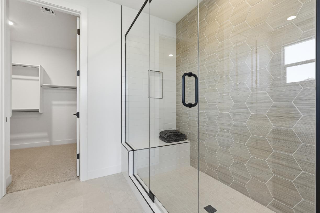 Primary bathroom with oversized walk-in shower and expansive closet