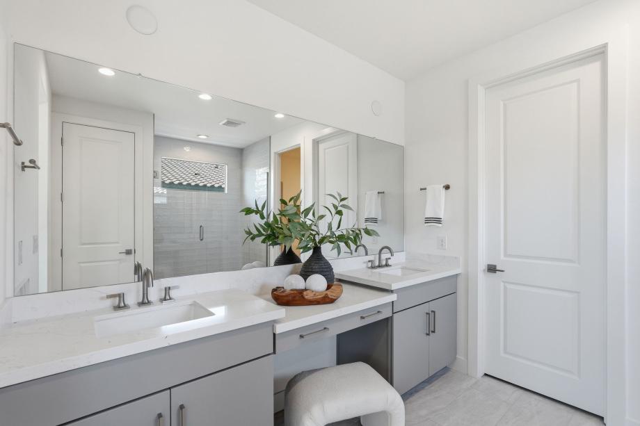 Serene primary bathroom with glass shower door and dual-sink vanity