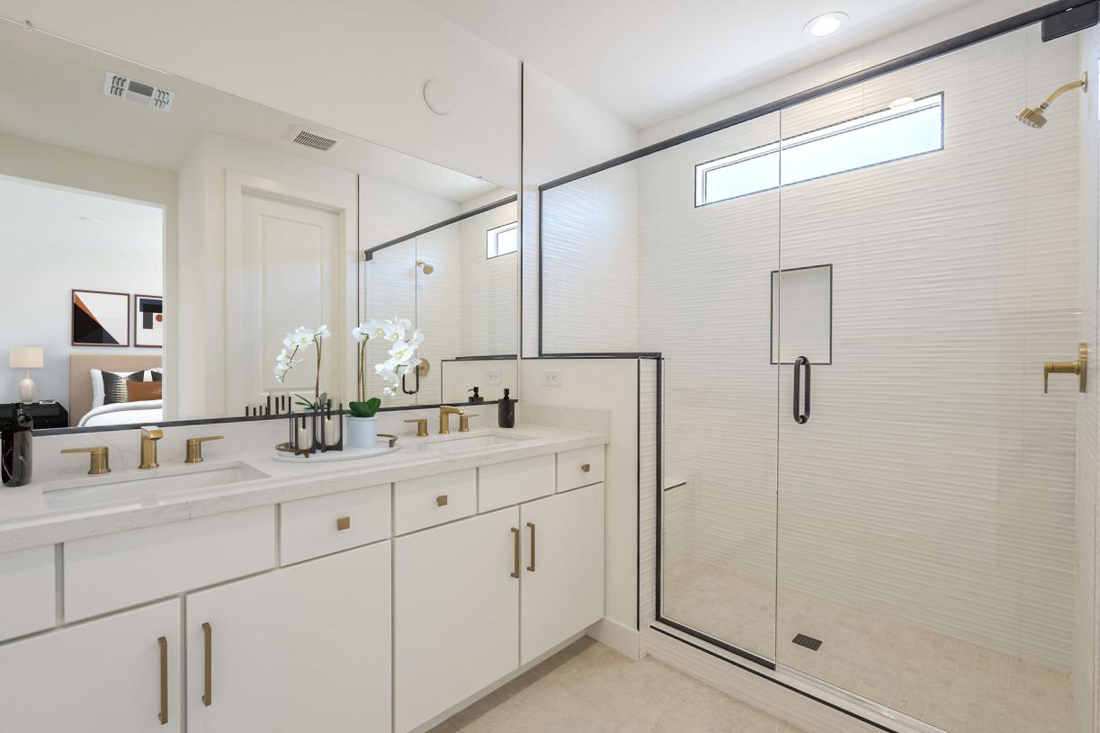 Primary bathroom with expansive shower, dual-sink vanity, and luxurious finishes