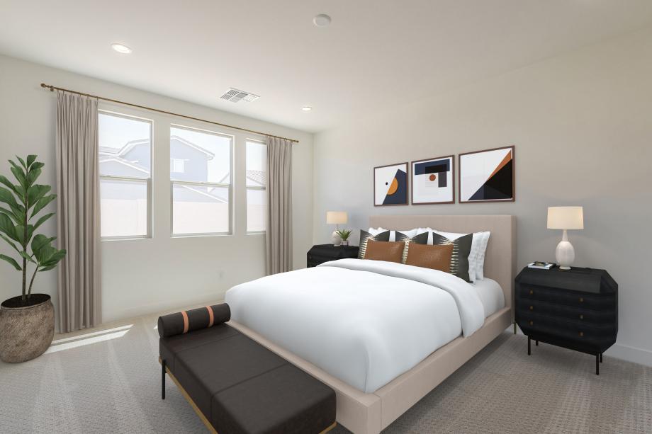 Primary bedroom suite with neutral finishes and an abundance of natural light