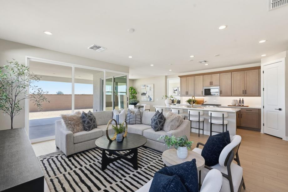 Spacious great room with direct patio access seamlessly leads into casual dining area and kitchen