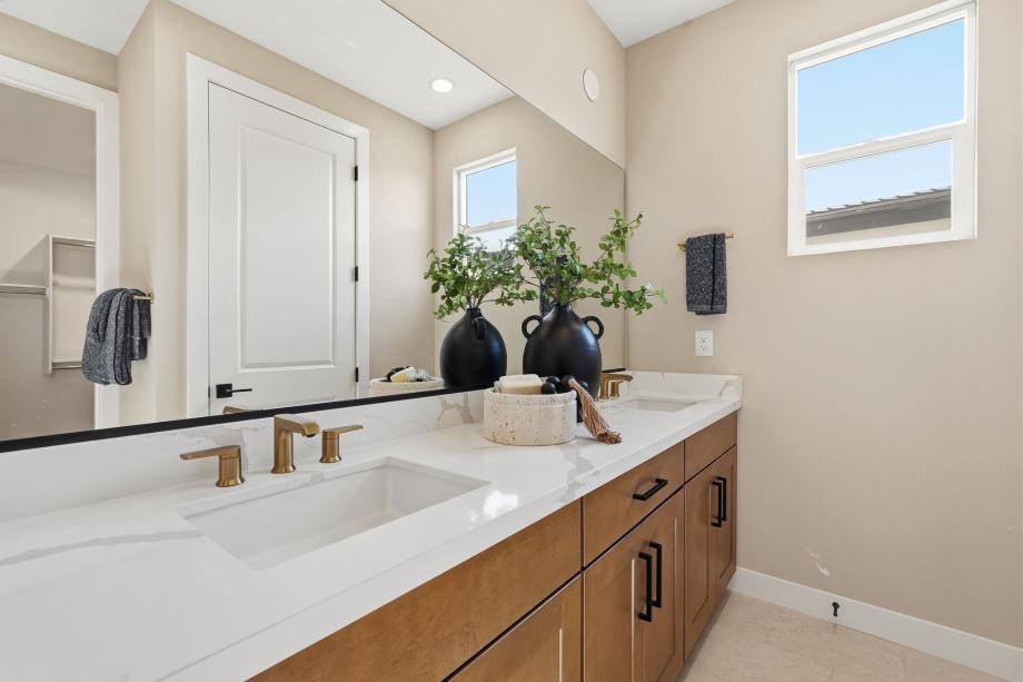 Serene primary bathroom with glass shower door and dual-sink vanity