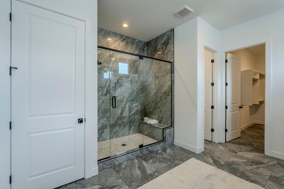 Primary bathroom with glass shower door and expansive closet