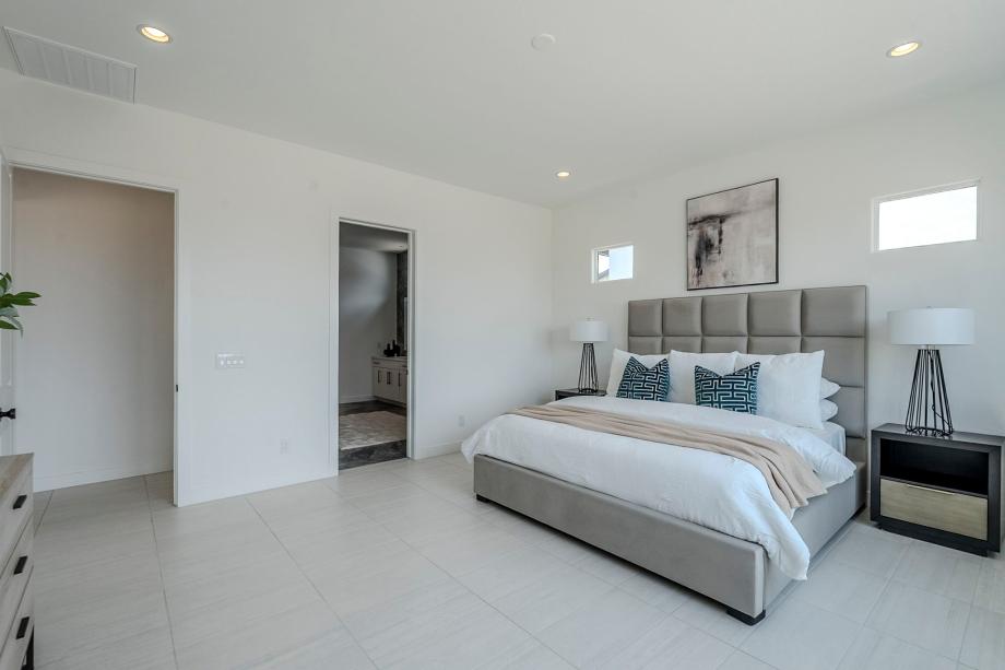 Stunning primary bedroom suite with beautiful flooring