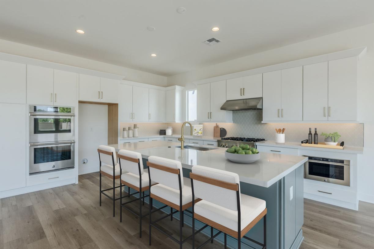 Beautiful kitchen with upgraded cabinets, gorgeous tile backsplash, and spacious island