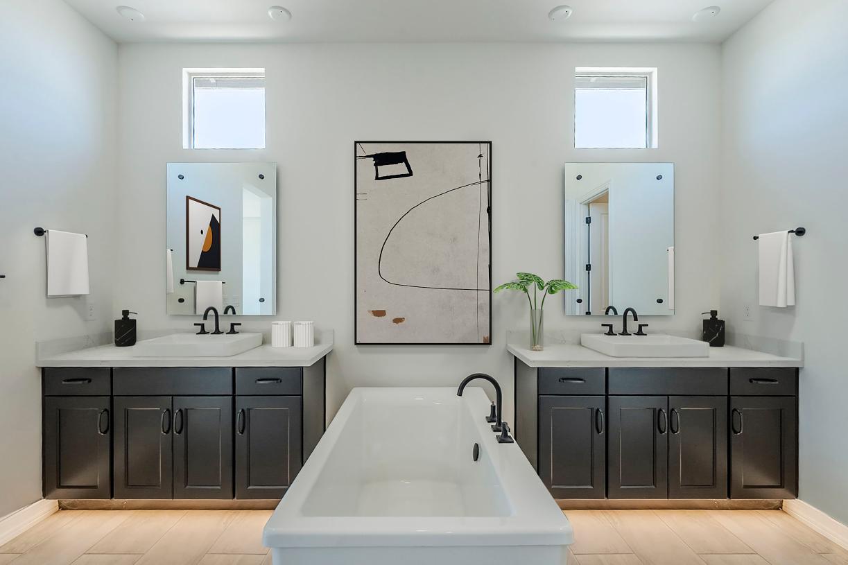 Gorgeous primary bathroom with dual vanities and a standalone tub