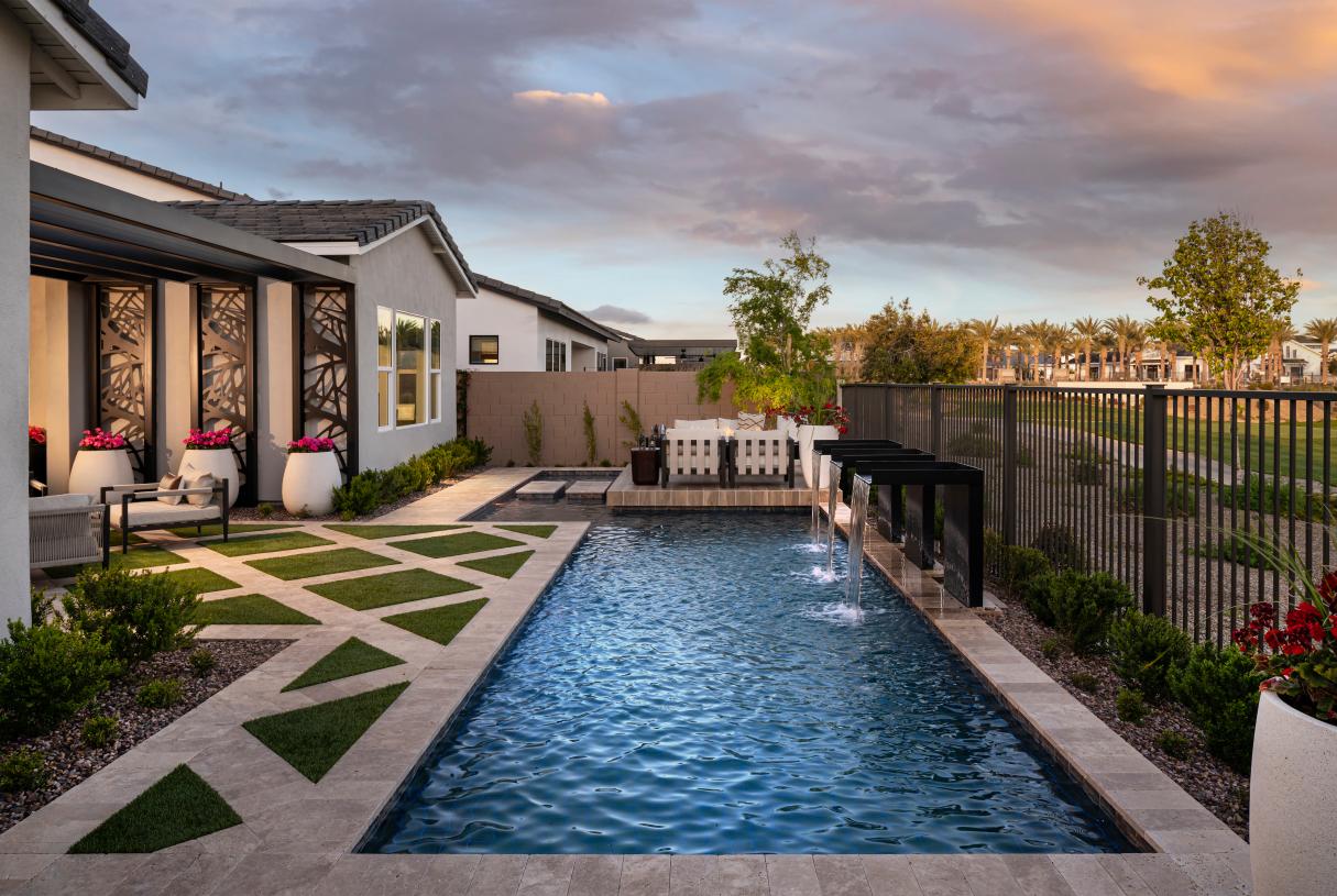Striking backyard area complete with water features and an expansive pool