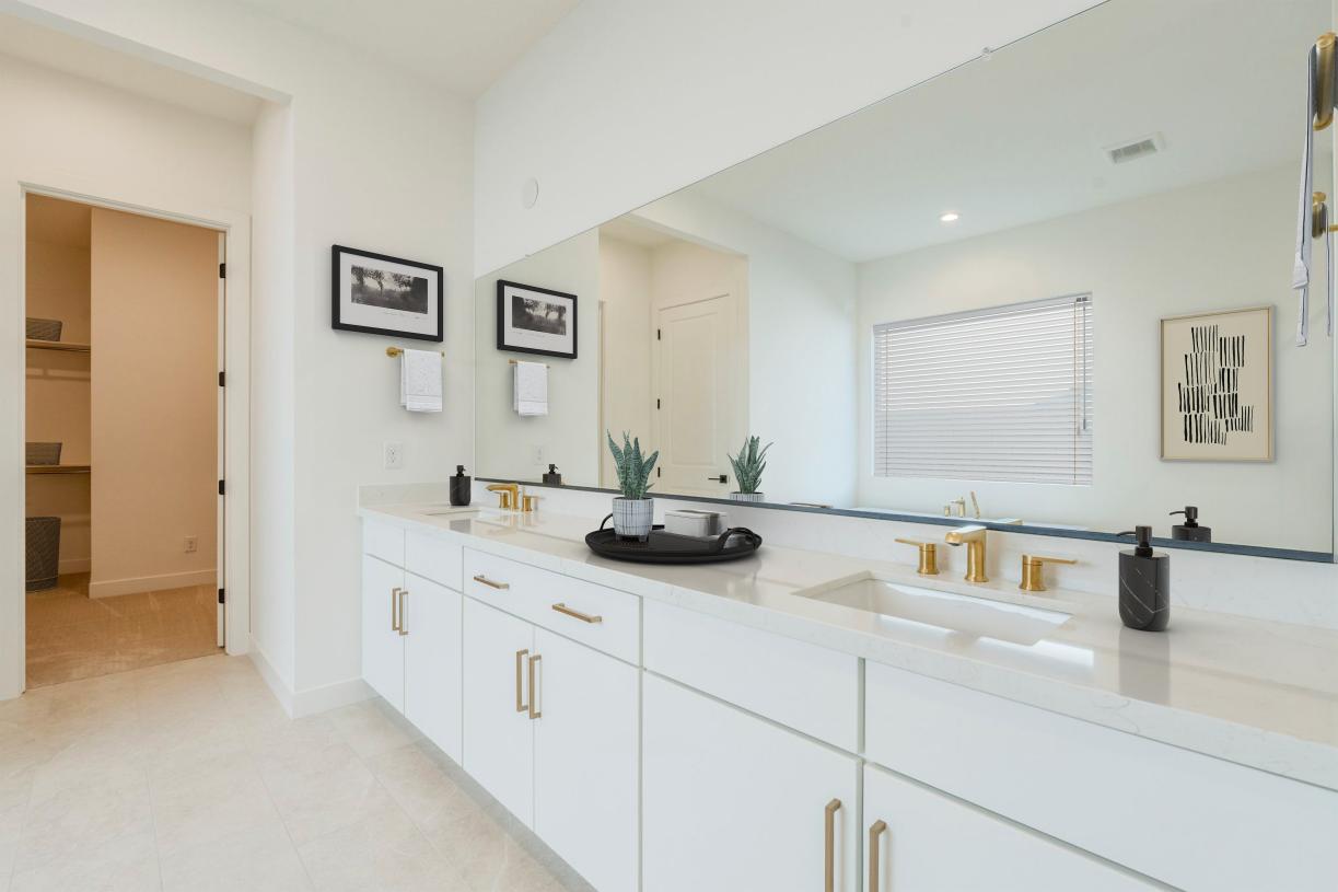 Serene primary bathroom with glass shower door, standalone soaking tub, and dual-sink vanity