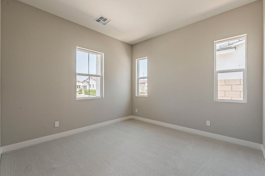 Spacious secondary bedroom with neutral finishes