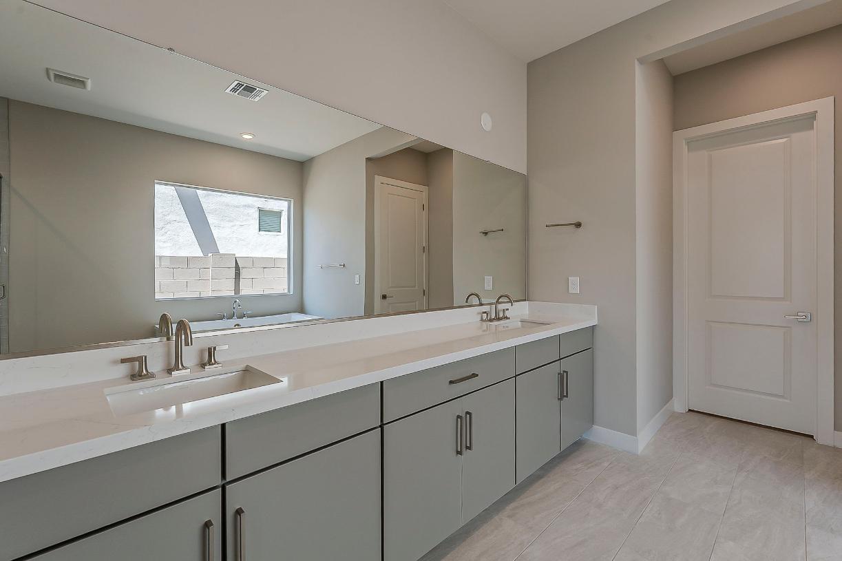 Spa-like primary bathroom with dual-sink vanity