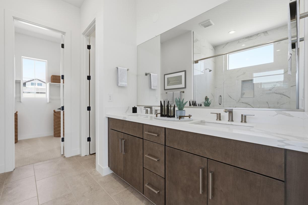 Gorgeous primary bathroom with dual-sink vanity and glass shower door