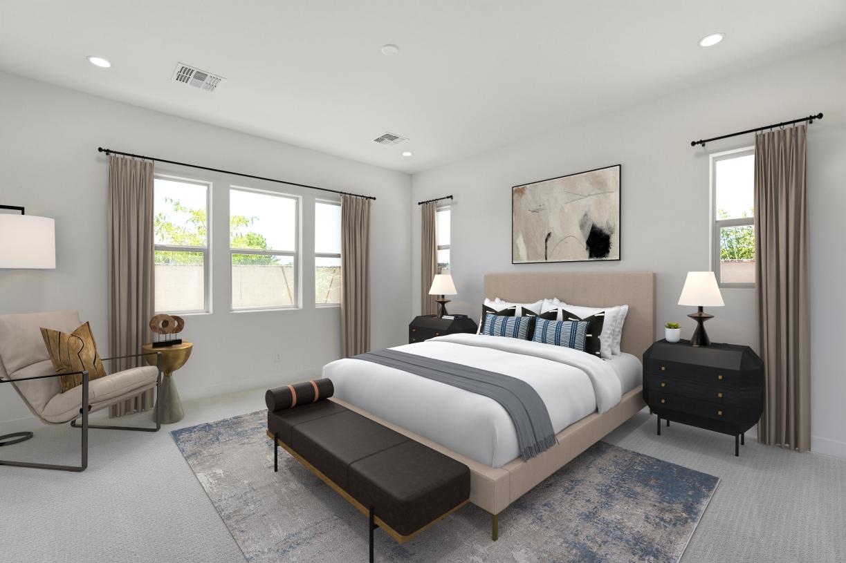 Serene primary bedroom suite with gorgeous windows and neutral finishes