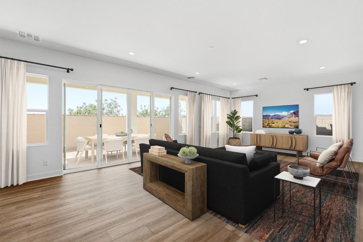 Spacious great room with beautiful flooring and sliding glass door leading to backyard