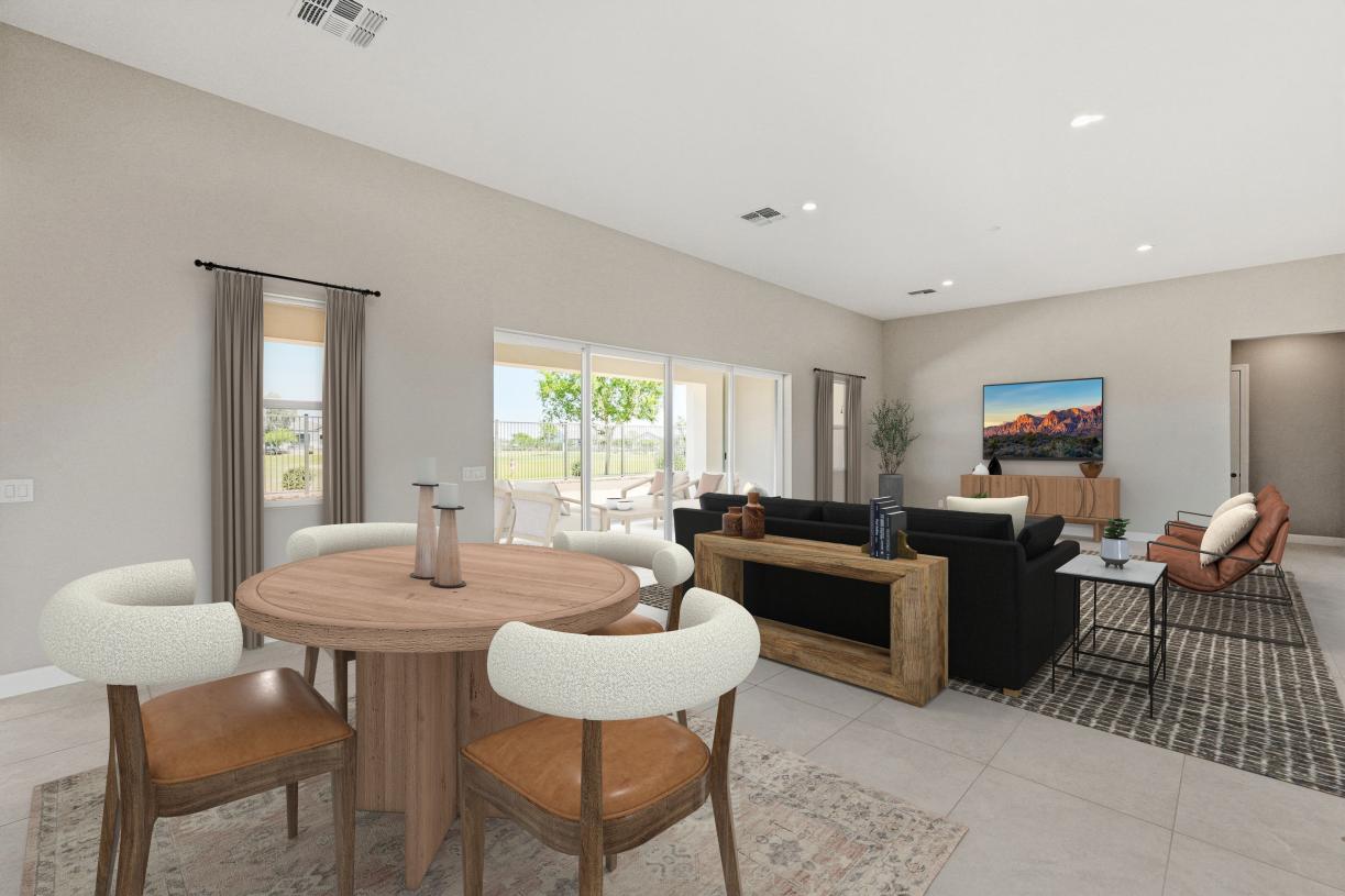 Spacious great room with beautiful flooring and sliding glass door leading to backyard