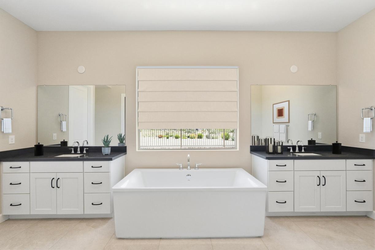 Primary bathroom with glass shower door and dual-sink vanity