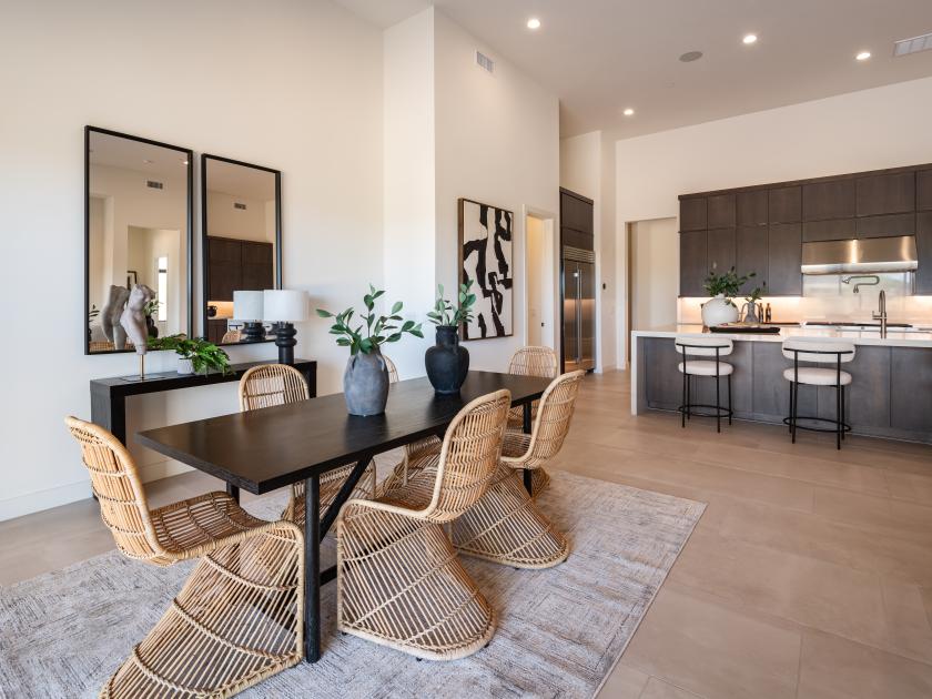Great room with a striking stone fireplace flows into an open kitchen concept