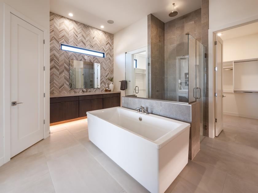 Primary bathroom with standalone tub and glass shower door