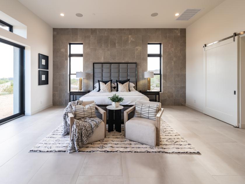 Gorgeous primary bedroom suite with neutral finishes, including a striking accent wall