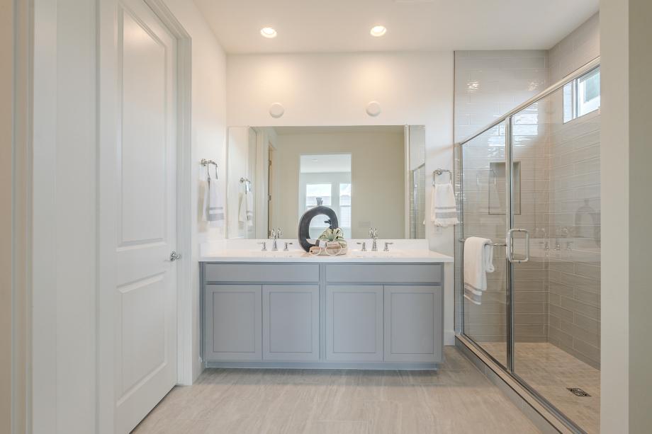 Primary bathroom with glass shower door and dual-sink vanity