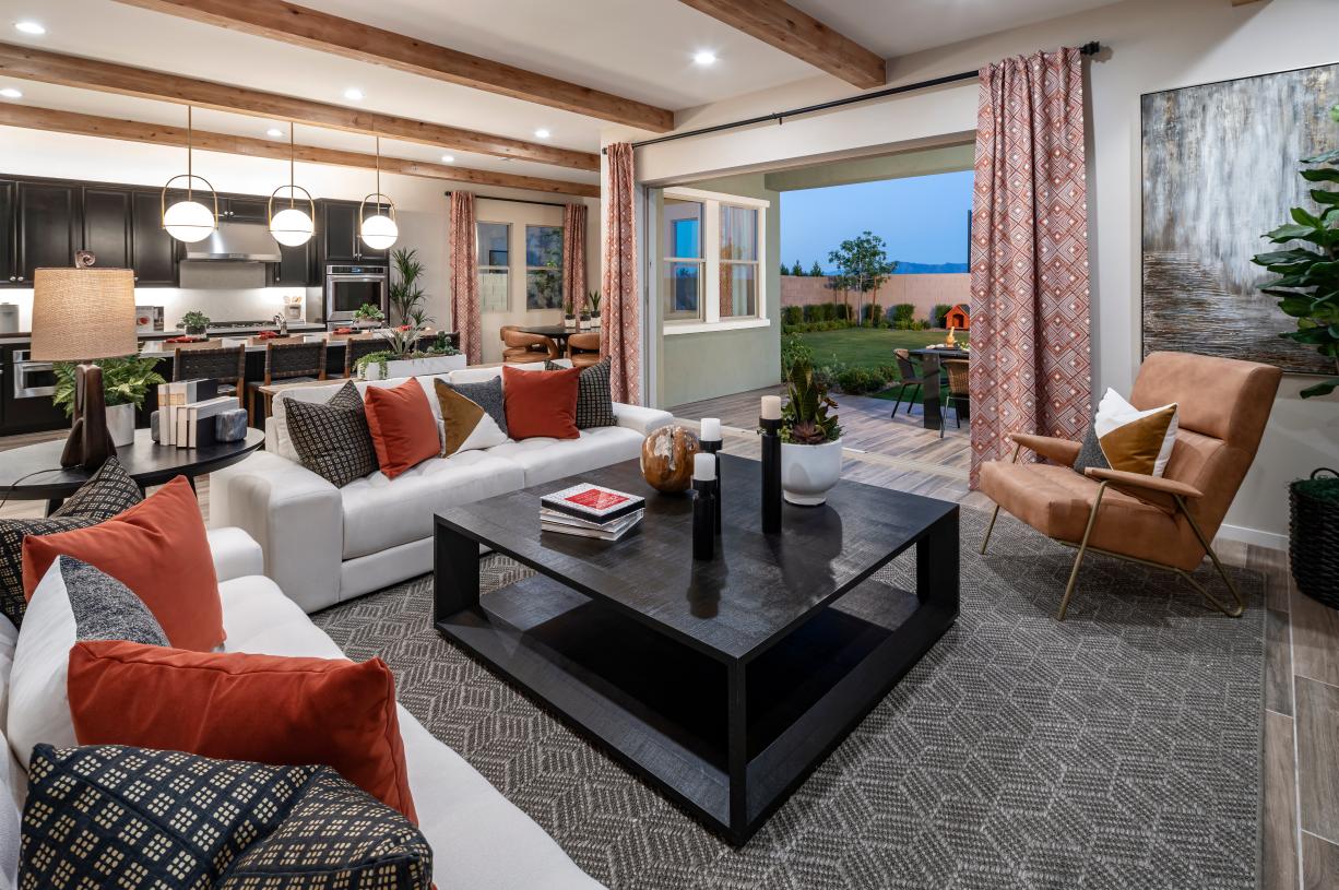 Beautiful open-concept great room with views of the kitchen, casual dining area, and outdoor living space beyond