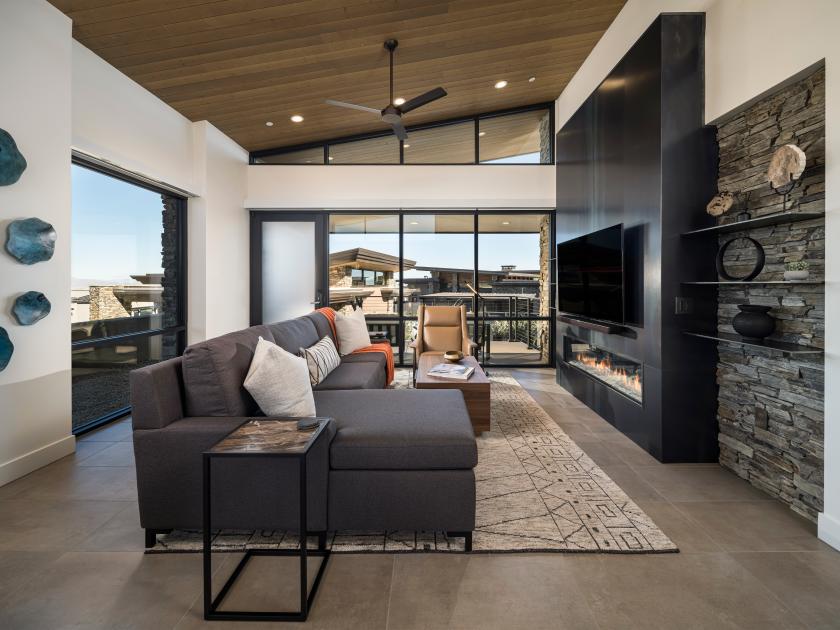 Open great room with fireplace, vaulted ceilings, and multi-slide patio door