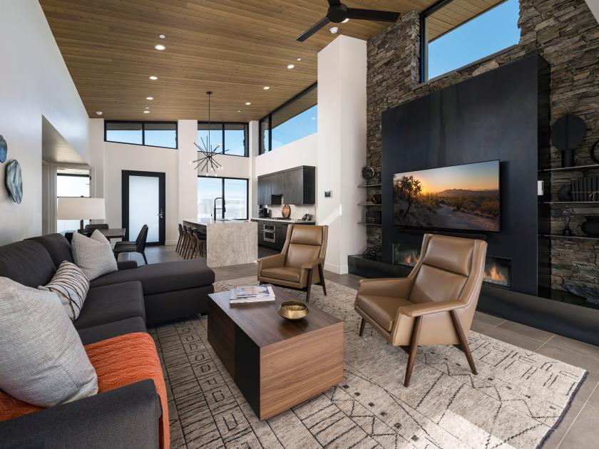 Open great room with fireplace, vaulted ceilings, and multi-slide patio door