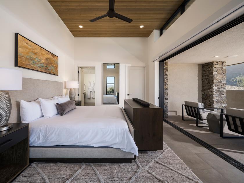 Serene primary bedroom suite with direct access to covered patio