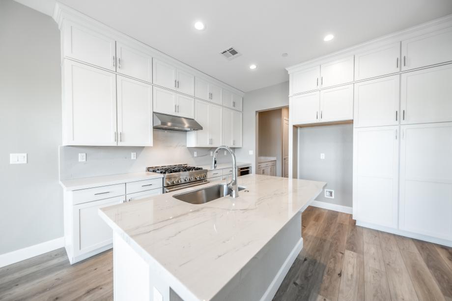 Beautiful white kitchen with stainless steel appliances