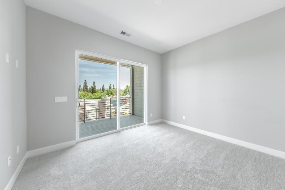 Spacious primary bedroom suite with covered deck