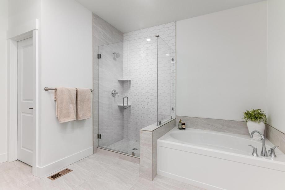Elegant primary bath highlighted by a fully tiled shower and bathtub
